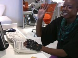 Young african-American smiling working on computer at hair salon. Stock Footage