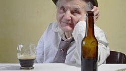 Elderly woman with glass of dark beer. Stock Footage