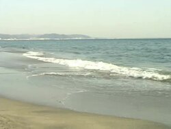 Pacific Ocean waves crashing to the beach in afternoon Stock Footage