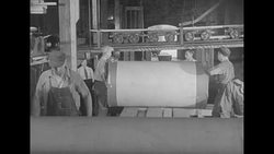 Miniature railroad-style conveyor operates inside Chicago Tribune paper storage warehouse News Clip