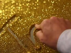 hand writing'trust' on golden sand background Stock Footage