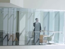  WS Businessman answering cell phone, seen through interior office windows / Seattle, Washington, United States Stock Footage
