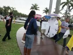 Long tracking shot to mid tracking shot of protesters marching and chanting slogans Immigration Activists Protest Outside Of Marco Rubio Fundraiser at Biltmore Hotel on April 05, 2013 in Miami, Florida (Footage by Getty Images)Immigration Activists Protest Stock Footage