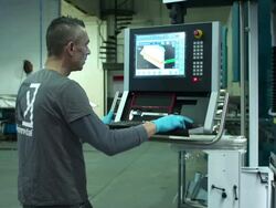 Dolly in on man setting the bending machine's computer. Stock Footage