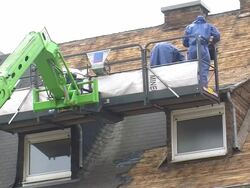 MS Housebreakers removing asphalt roof / Saarburg, Rhineland-Palatinate, Germany Stock Footage