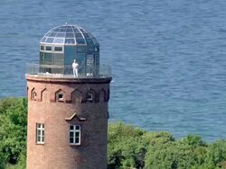 CU AERIAL View of light house and man standing on light house / Hiddensee, Mecklenburg-Vorpommern, Germany Stock Footage