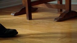 A child walks in a pair of men's shoes. Stock Footage