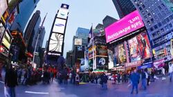 Pedestrians walk past the large neon signs and billboards on Times Square in New York City. Stock Footage
