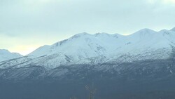 Clouds race above snowy mountains. Stock Footage