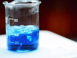 Boiling blue liquid in beaker Stock Footage
