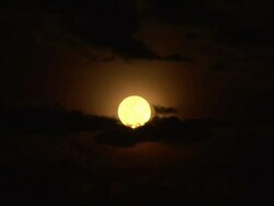 Full moon against the dark sky with clouds Stock Footage