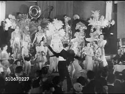 1920s: NEW YORK CITY: SPEAKEASY ENTERTAINMENT: CU Bartender shaking cocktail, female dancers dancing routine in dance floor spotlight, CU Bartender shaking cocktail, VS Dancing couple, dancer alone, dancer dancing in front of standing musicians. Instructional Video