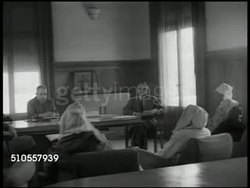 1951: FRENCH-MOORISH COMMISSION: EXT French-Moorish Commission building. INT Meeting w/ Moroccan people in traditional clothing, sitting in chairs, French Commissioner sitting at desk, each talking to the other, no SOT. Instructional Video