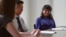MS Smiling businesspeople listening to coworker during team meeting in office conference room Stock Footage