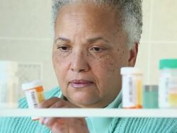 CU Senior Woman Taking Prescription Bottle from Medicine Cabinet / Richmond, Virginia, USA Stock Footage