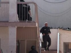 April 9 2009 WS TS TD Police officers leaving house after search, Juarez, Chihuahua, Mexico, AUDIO Stock Footage