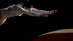 SLO MO DS Female gymnast performing front handspring on vault Stock Footage