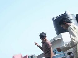 Two boys flying kite, Delhi, India Stock Footage