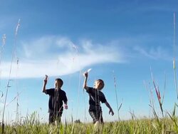 Two boys fly paper airplanes Stock Footage