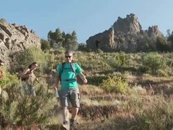 People hiking through rural landscape and looking at map Stock Footage