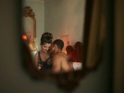 Reflection in mirror of loving young couple on bed  Stock Footage