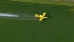 A yellow crop duster sprays crops with pesticide. Stock Footage