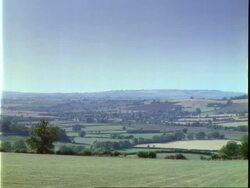 T/L view over small village and surrounding fields, lapse time/locked shot, Long Compton Stock Footage