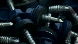 Heap of blue screws with rubber gaskets and flat washers Stock Footage