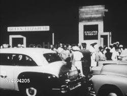 1953: SUPERLINER: VS People & cabs at port dock w/ Queen Elizabeth sign, TU WS People standing along railing on passenger ship, MS Cabs at dock TU WS Bow of RMS Queen Elizabeth luxury Cunard White Star Line ocean liner. Instructional Video
