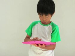 A boy using a tablet earnestly Stock Footage