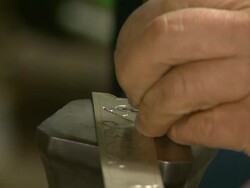 Craftsperson is carving on iron plate and hammering Stock Footage
