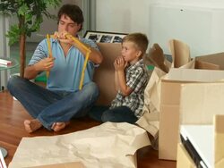 Father and Son Using Folding Ruler Stock Footage