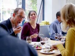 MS R/F group of friends sitting at table in restaurant eating dinner Stock Footage
