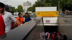 A busy entry/exit point to the underground section of the Delhi Metro at the Rajic Chowk station, Connaught Place, New Delhi Stock Footage