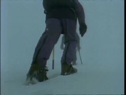 MS low angle view of people's spiked boots trekking up snowy mountainside, Rwenzori Mountains, Uganda Stock Footage