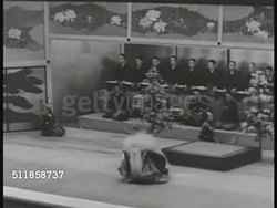 1930s: TOKYO, JAPAN: CULTURAL EVENT: WS EXT Kabuki-za theater. HA WS Kabuki traditional theater stage w/ actor in costume dancing as the White Lion in 'Renjishi', musicians playing BG. (dark contrast, live performance) Instructional Video