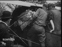 1918: AIRMAIL SERVICE DEDICATION: WS US Post Office official 'Air Mail Service' truck w/ people standing behind fence BG, men stuffing mail bags into biplane, President Woodrow Wilson talking w/ unidentified pilot, pilot into #38 biplane. Instructional Video