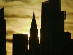 The golden sun rises up behind the Chrysler Building early morning in Manhattan Stock Footage