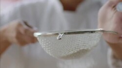 Pastry chef sifts flour with sieve in gourmet restaurant Stock Footage