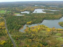 WS ARIEAL View of River along wooded area / Maine, United States Stock Footage
