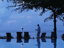 waiter serving a drink by a resort pool Stock Footage