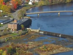 WS ARIEAL ZI ZO View of City with dam / Maine, United States Stock Footage
