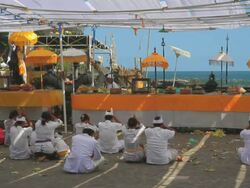 MS Worshippers at Tanah Lot Temple and waves crashing on rocks Uluwatu / Kediri, Bali, Indonesia Stock Footage