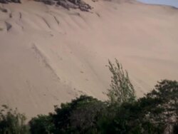 "Pan up from green crops to sandy mountain, rural La Libertad, Peru [PerÃƒÂº]" Stock Footage