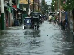Motorbikes driving through flood waters in Cupang in aftermath of typhoon Mirinae, Philippines, 2009 Stock Footage