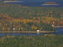 WS AERIAL ZI PAN View of wooded area with autumn color and lakes / Maine, United States Stock Footage