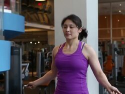 Medium shot of woman exercising at the gym, jumping rope. Stock Footage