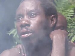 CU Shot of  batwa man looking from smoke / Kigez, Kabale, Uganda Stock Footage
