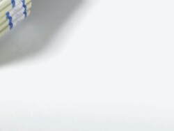 CU SLO MO Shot of Wads of 1 US Dollar Banknotes falling against White Background / Calvados, Normandy, France Stock Footage