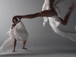 two woman draped with silk around them running across screen Stock Footage